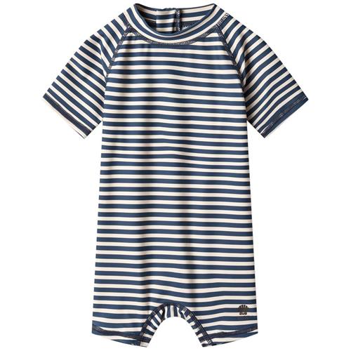 Se Wheat Cas Stribet UV-dragt Indigo | Marine blå | 74 cm ved Babyshop