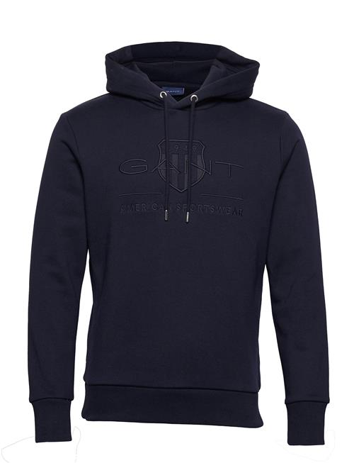 Se GANT Reg Tonal Shield Hoodie GANT Navy ved Booztlet