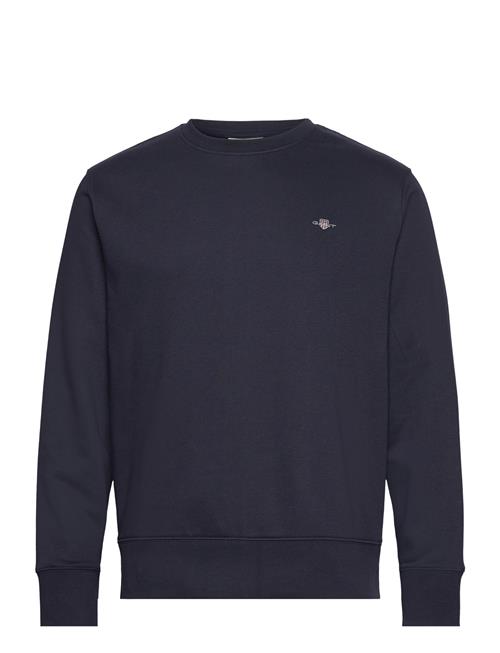 Se GANT Reg Emb Archive Shield Cneck GANT Navy ved Booztlet