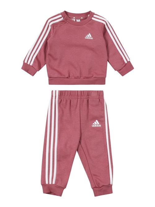 Se ADIDAS SPORTSWEAR Træningsdragt 'Essentials'  melon / hvid ved About You